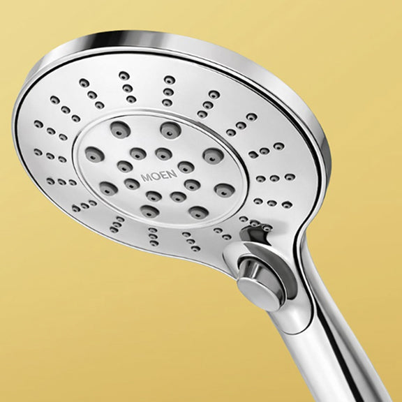 Chrome handheld showerhead with multiple spray nozzles and a lever, against a beige background.