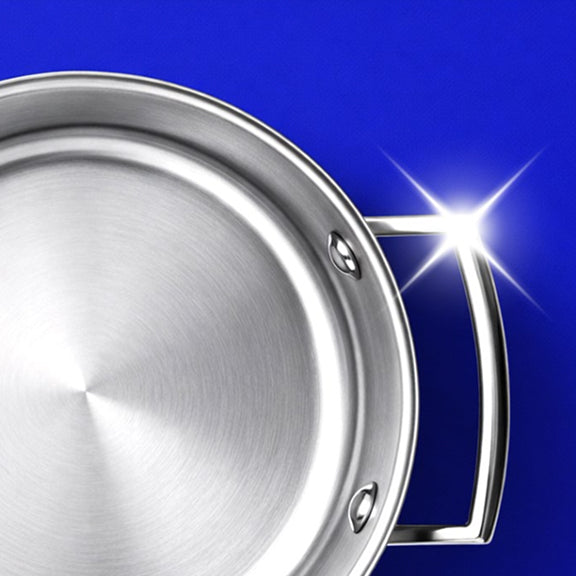 Top view of a shiny stainless steel pan with a reflective handle against a blue background.