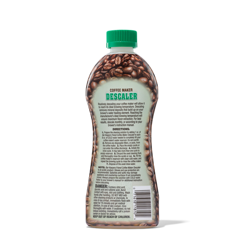 Bottle of coffee maker descaler with instructions and warnings on the label, featuring coffee beans design and a green cap.
