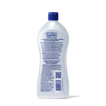 Bottle of cooktop cleaner with detailed usage and safety instructions on the back label.