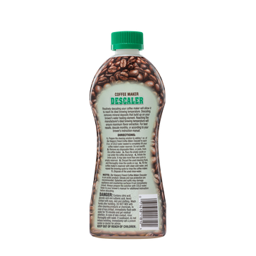 Bottle of coffee maker descaler with usage instructions and safety warnings on the back label.