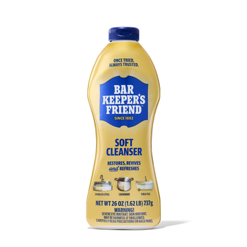 Yellow bottle of Bar Keeper's Friend soft cleanser with blue cap and label, showing uses for stainless steel, cookware, and t