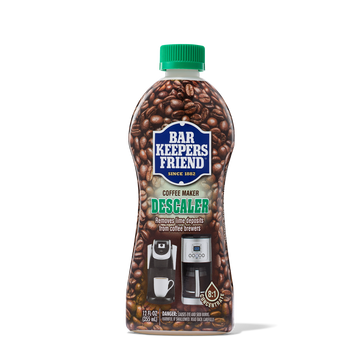 Bottle of Bar Keepers Friend Coffee Maker Descaler with coffee beans background and images of coffee makers on label.