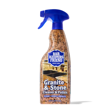 Spray bottle of Bar Keepers Friend Granite & Stone Cleaner & Polish with blue trigger and granite-patterned label.